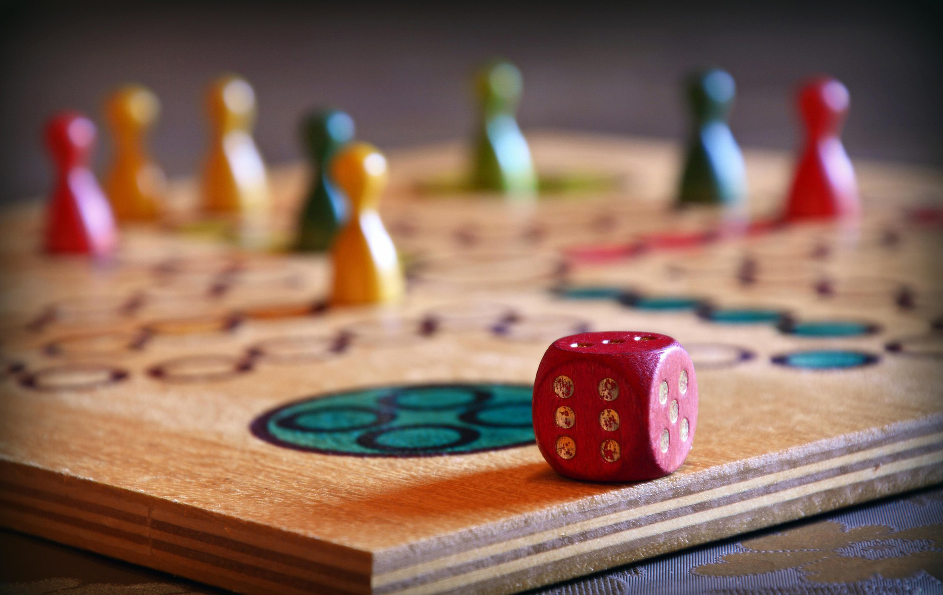 Foto: Spielfiguren und Würfel auf einem Spielfeld Foto: Spielfiguren und Würfel auf einem Spielfeld